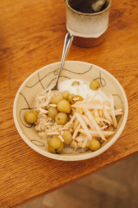 High angle view of breakfast on table, porridge with yogurt and tea, healthy eating.