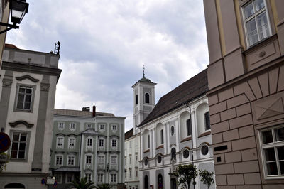 Low angle view of buildings in city against sky