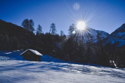 Snow covered landscape against blue sky