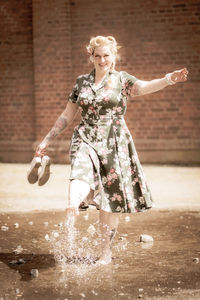 Woman with arms outstretched in mid-air