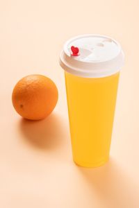 Close-up of orange juice against white background