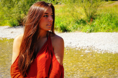 Portrait of beautiful young woman standing outdoors