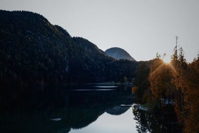 Scenic view of lake and mountains against clear sky