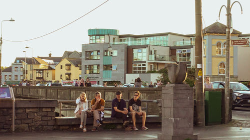 Group of people in front of buildings in city