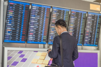 Rear view of man standing at airport