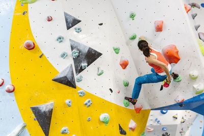 Woman climbing on wall