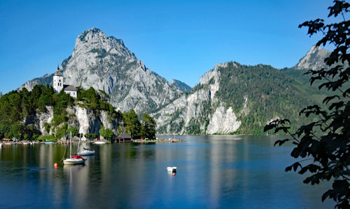 Scenic view of lake and mountains against sky