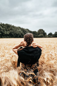 Rear view of woman standing on field