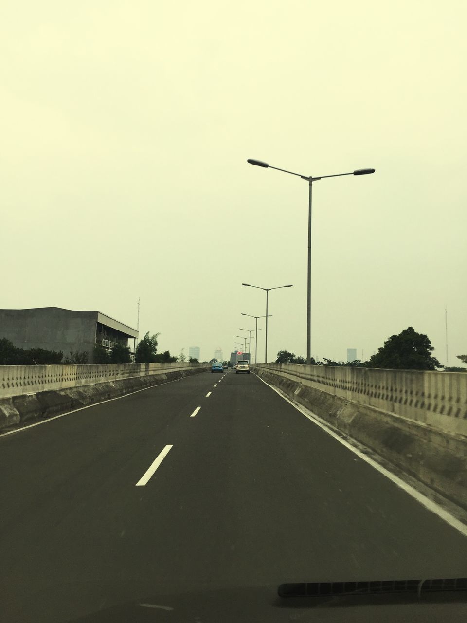 transportation, road marking, road, the way forward, clear sky, diminishing perspective, copy space, street, vanishing point, street light, car, asphalt, empty, mode of transport, sky, highway, empty road, land vehicle, arrow symbol, road sign