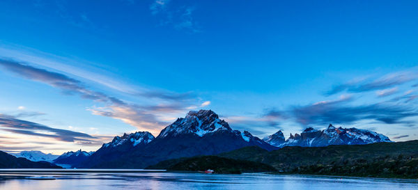 Scenic view of mountains against blue sky