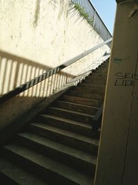 Staircase of text on railing against sky