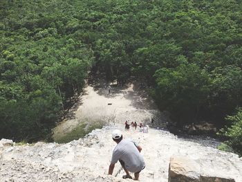 High angle view of man on steps in forest