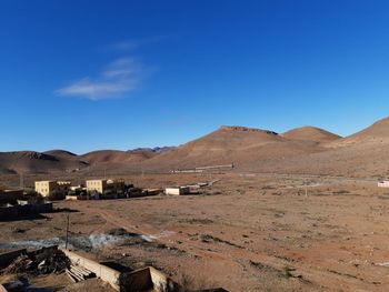 Scenic view of desert against blue sky