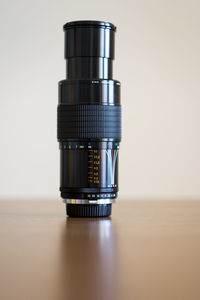 Close-up of camera on table against white background