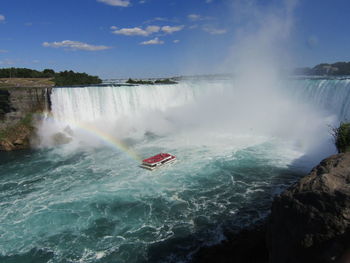 Boat in mist below niagara falls