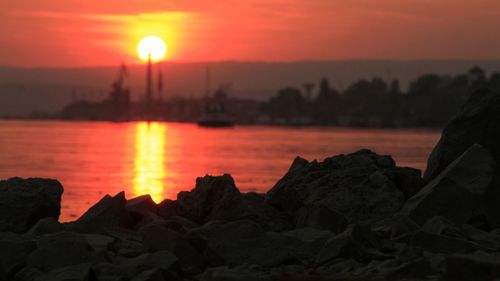 Scenic view of sea against orange sky