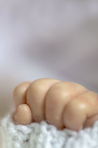 Close-up of baby lying on floor