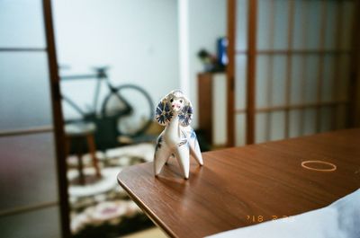 Close-up of figurine on table at home