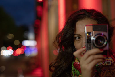 Beautiful woman photographing outdoors