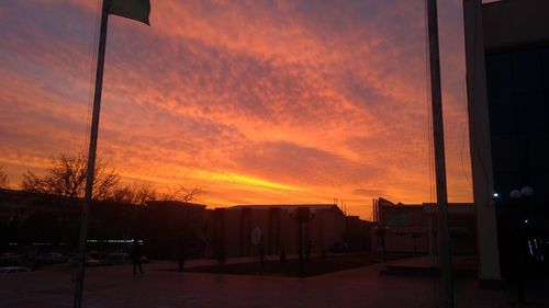 Silhouette buildings against sky at sunset