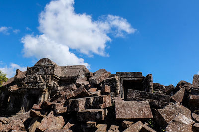 Low angle view of old ruins against blue sky