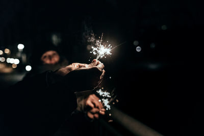 Close-up of sparklers in human hand