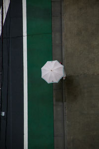 Close-up of umbrella on wall against building