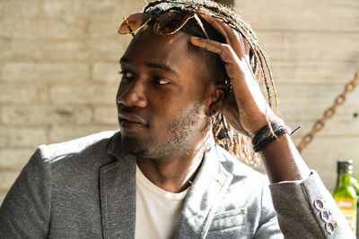 Close-up of thoughtful young man looking away while sitting in cafe