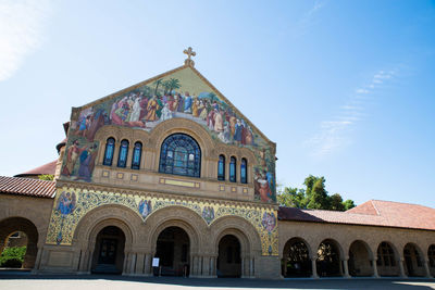 Low angle view of historical building against blue sky