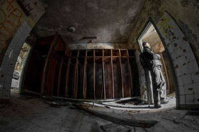 Full length of woman standing in old building