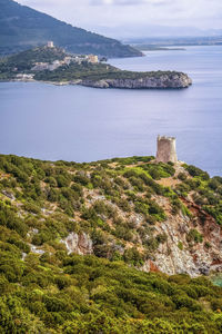 High angle view of sea and mountains against sky