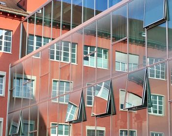 Low angle view of modern building with reflection