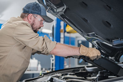 Side view of mechanic working in workshop