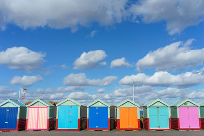 Multi colored umbrellas on beach against sky