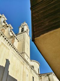 Low angle view of church against clear blue sky