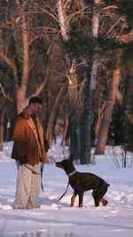 Side view of man standing in forest