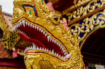 Close-up of angel statue against temple