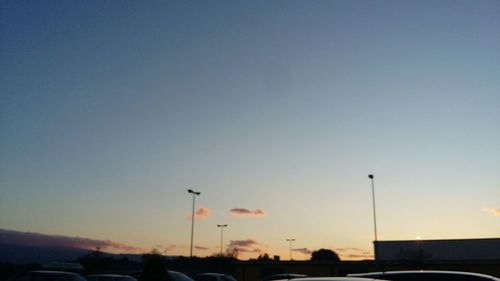 Silhouette of street light against clear sky