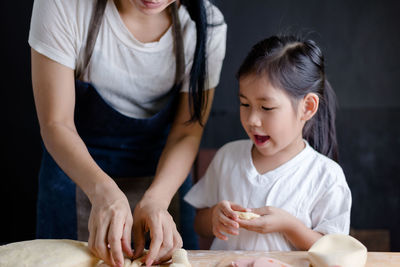 Mother and daughter cooking in kitchen