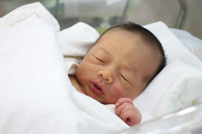 Cute baby sleeping in bed