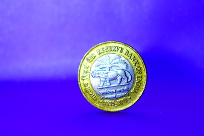 Close-up of coin against blue background