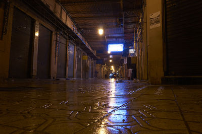 Illuminated walkway in city at night