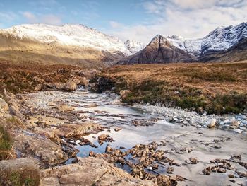 Waterfall between sharp exposed rocks, the fairy pools, scotland. trek by popular river brittle