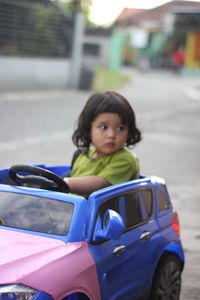 Portrait of cute girl in car