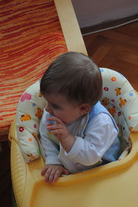 High angle view of cute baby girl sitting at home