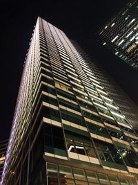 Low angle view of illuminated building against sky at night