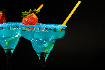 Close-up of beer glass against black background