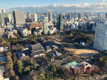 High angle view of trees and buildings in city