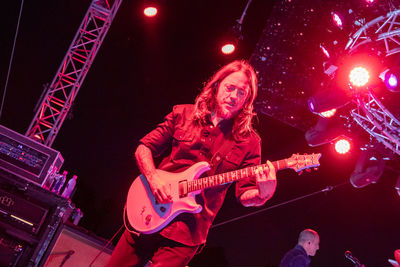 Low angle view of playing guitar at night