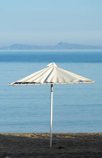 Lifeguard hut on beach against sky